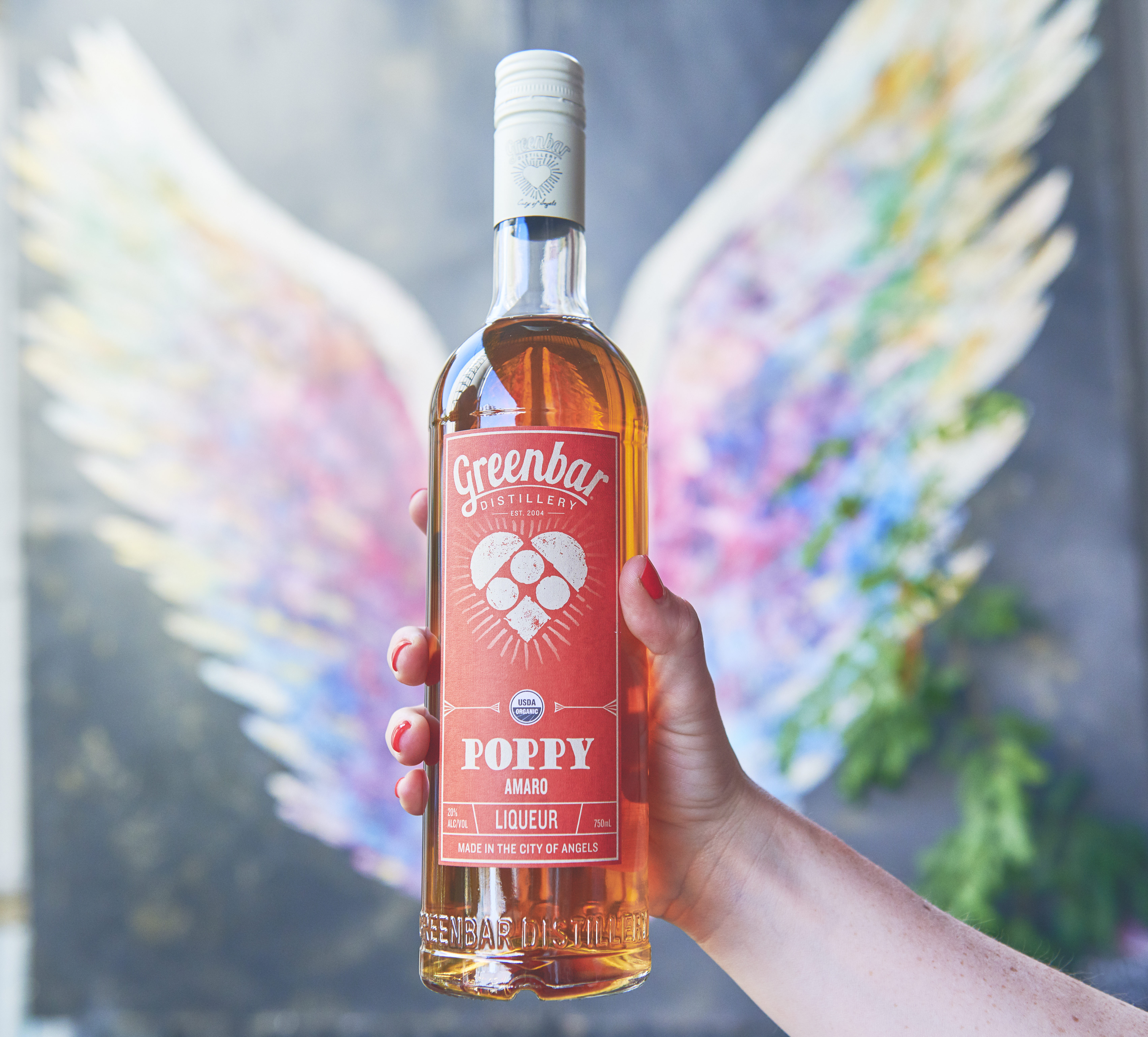 Greenbar Distillery Poppy amaro against angel wings graffiti